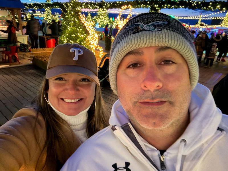 Artie and April at a lit-up winter market